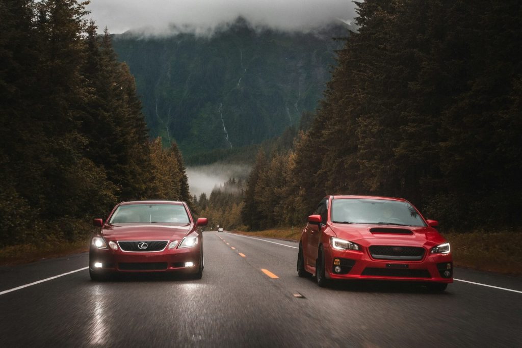 two red cars on road